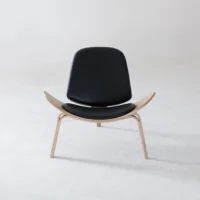 A modern black lounge chair with wooden legs and a curved seat, photographed against a plain light grey background.