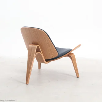 Microfiber leather Shell Chair in natural plywood by Hans Wegner, back right facing view.