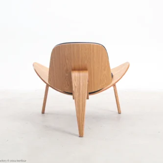 Microfiber leather Shell Chair in natural plywood by Hans Wegner, back facing view.