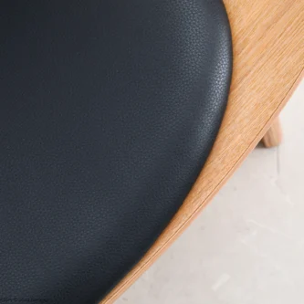 Detail of microfiber leather Shell Chair in natural plywood by Hans Wegner.