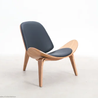 Microfiber leather Shell Chair in natural plywood by Hans Wegner, front right facing view.