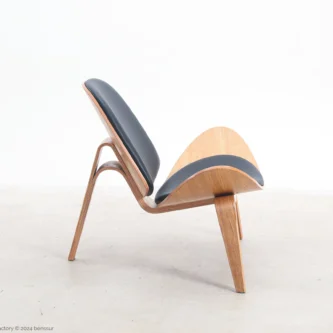 Microfiber leather Shell Chair in natural plywood by Hans Wegner, right facing view.