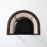 A top-down view of a modern chair with a curved brown wooden frame, beige cane backrest, and black cushioned seat against a light grey background.