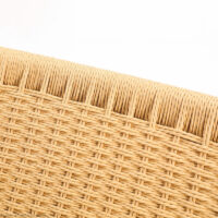 Close-up view of a woven rattan or wicker surface, showing detailed textured pattern in light tan colour against a white background.