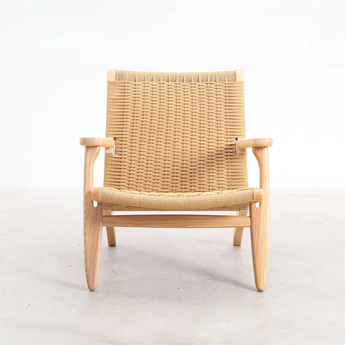 Easy Chair_B9 A wooden armchair with a woven seat and backrest, featuring light-coloured wood and a minimalist, Scandinavian design, photographed against a plain white background.