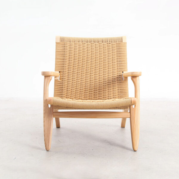 A wooden armchair with a woven seat and backrest, featuring light-coloured wood and a minimalist, Scandinavian design, photographed against a plain white background.