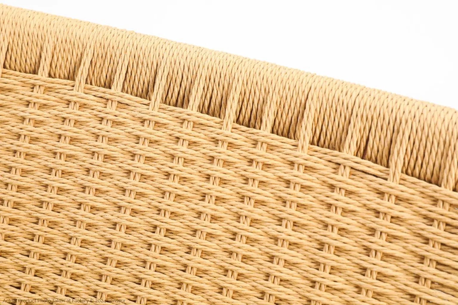 Hans Wegner_CH25 Easy Chair_Replica_Paper Rope_Natural_Ash_Detail_2 Close-up view of woven wicker or rattan material in a light tan colour, showing the detailed texture and pattern of the interlaced strands.