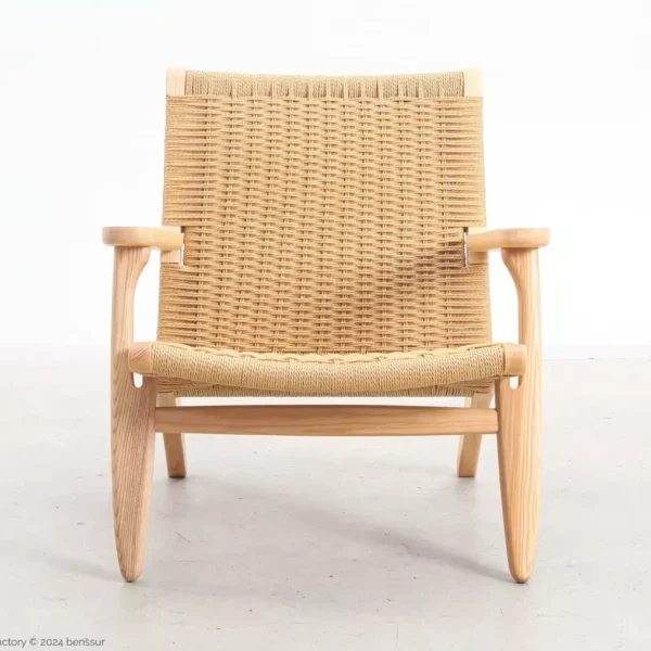 A wooden lounger with a light wood frame and woven rattan seat and backrest, photographed against a plain white background.