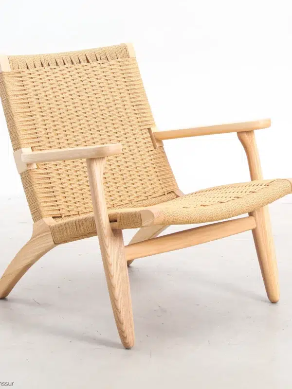 ront-side view of Hans Wegner's CH25 Easy Chair, showcasing its woven seat and backrest along with the solid wooden frame.