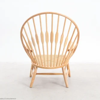 Paper rope Peacock Chair in natural ash by Hans Wegner, back facing view.