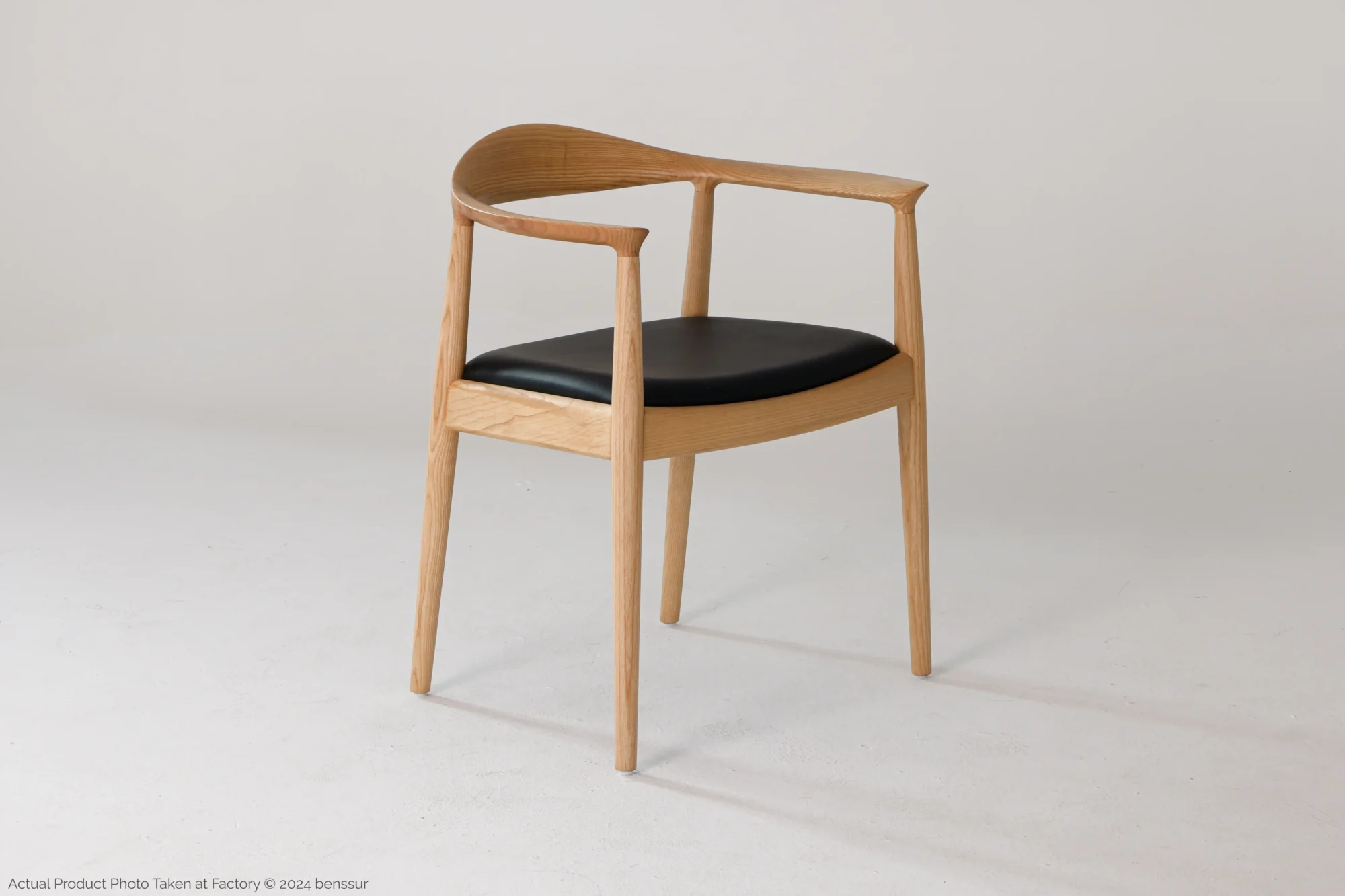 Microfiber Round Chair in natural ash by Hans Wegner, front right facing view.