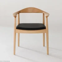 A wooden chair with curved armrests and a black cushioned seat, set against a plain white background. The design is minimalist and modern.