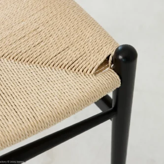 Detail view of A solid ashwood wishbone chair finished in black.