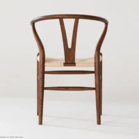 A wooden chair with a curved backrest and a woven seat, shown from behind against a plain white background.