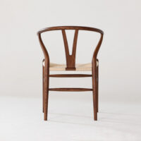 A wooden chair with a curved backrest, Y-shaped central support, and a woven seat, photographed against a plain white background.