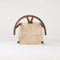 A modern wooden chair viewed from above, featuring a woven beige seat and elegantly curved wooden armrests, set against a plain light background.