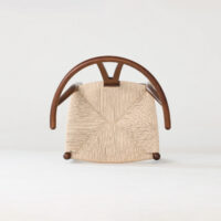 A modern wooden chair viewed from above, featuring a woven beige seat and elegantly curved wooden armrests, set against a plain light background.