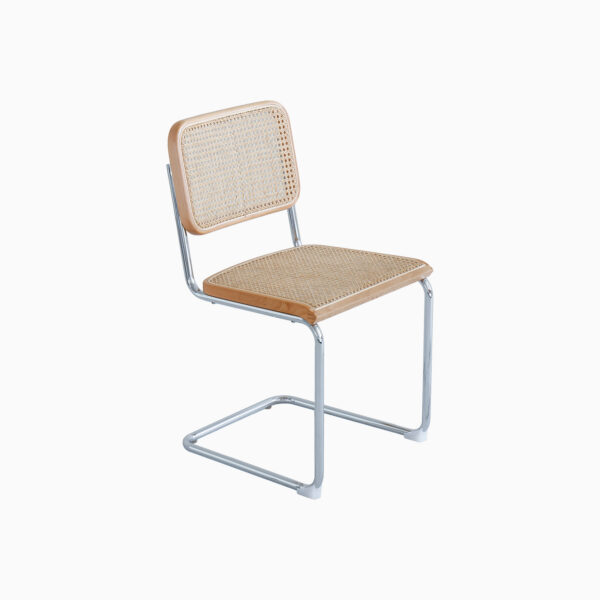A modern chair with a chrome cantilever frame, light wood accents, and a woven cane seat and backrest, set against a plain white background.