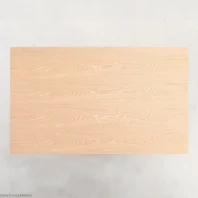 A rectangular wooden table top with a light natural finish, viewed from above, set against a plain light background.