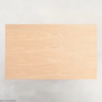 A rectangular wooden table top with a light natural finish, viewed from above, set against a plain light background.