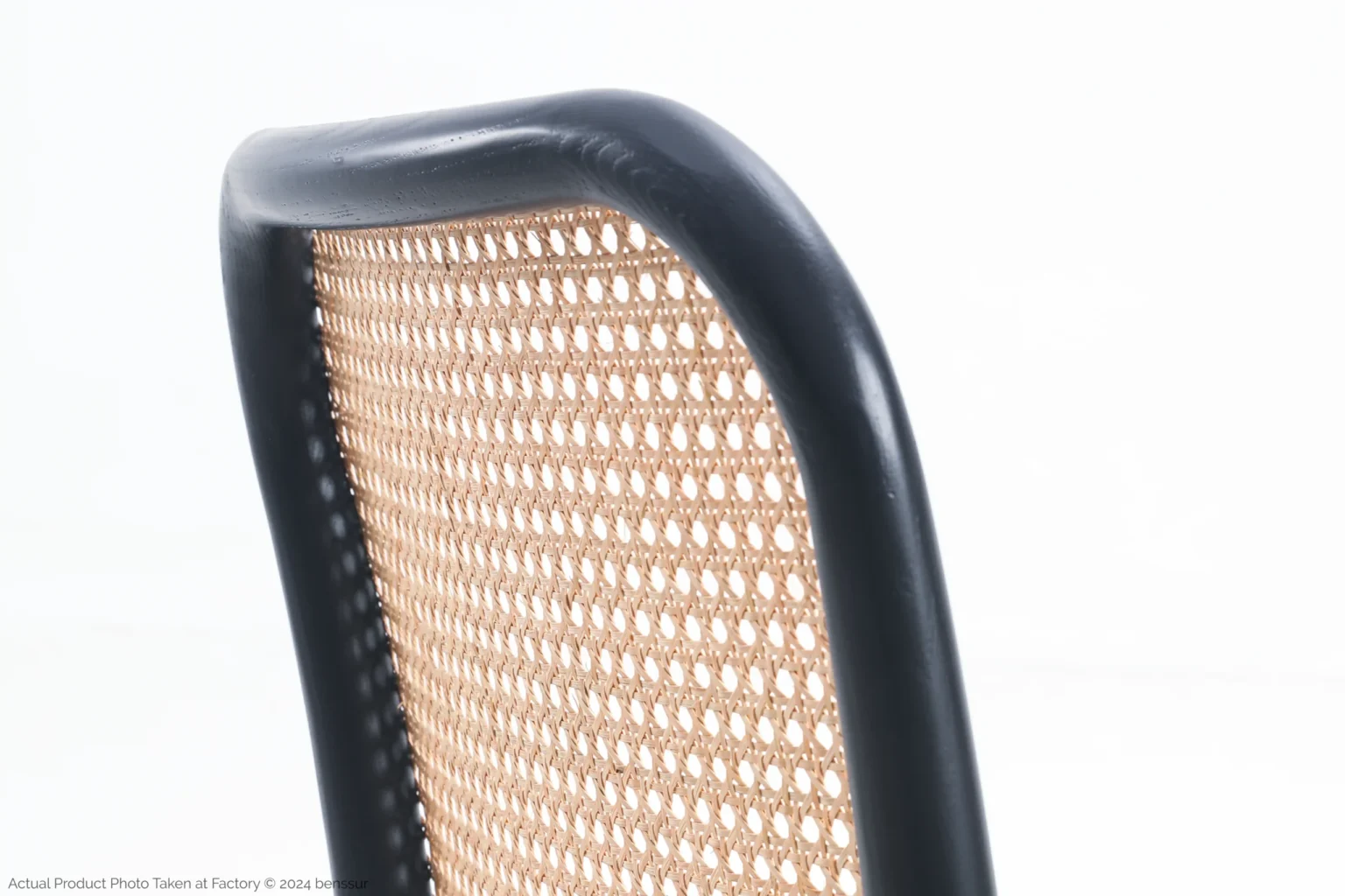 Josef Hoffmann_No811 Chair_Replica_Upholstered_Black_Ash_Detail_2 Close-up of a chair backrest with a black wooden frame and woven cane webbing, set against a plain white background.