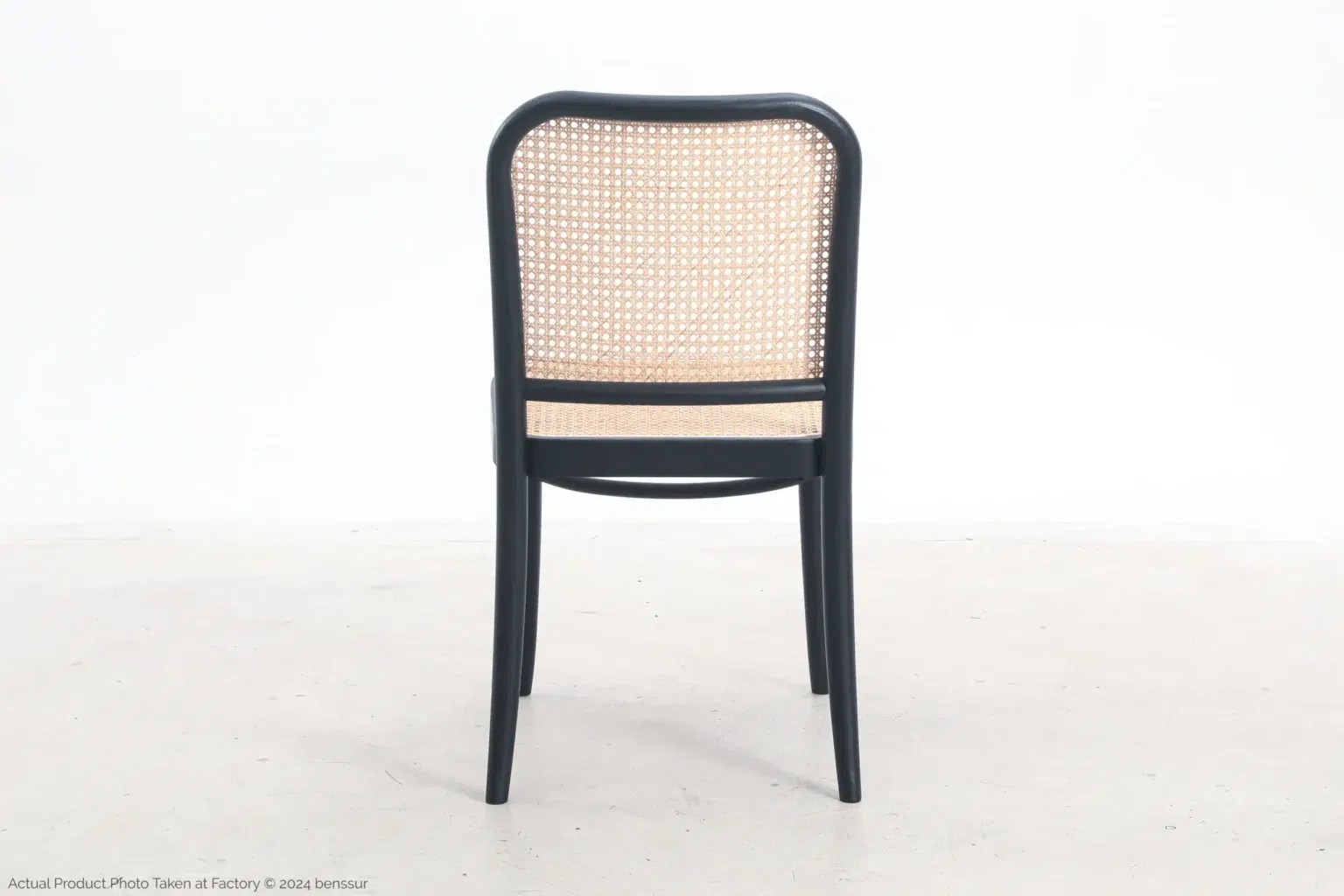Josef Hoffmann_No811 Chair_Replica_Woven Caning_Black_Ash_Back A wooden chair with a black frame and a woven cane backrest and seat, shown from the back, standing on a plain light-coloured floor against a white background.