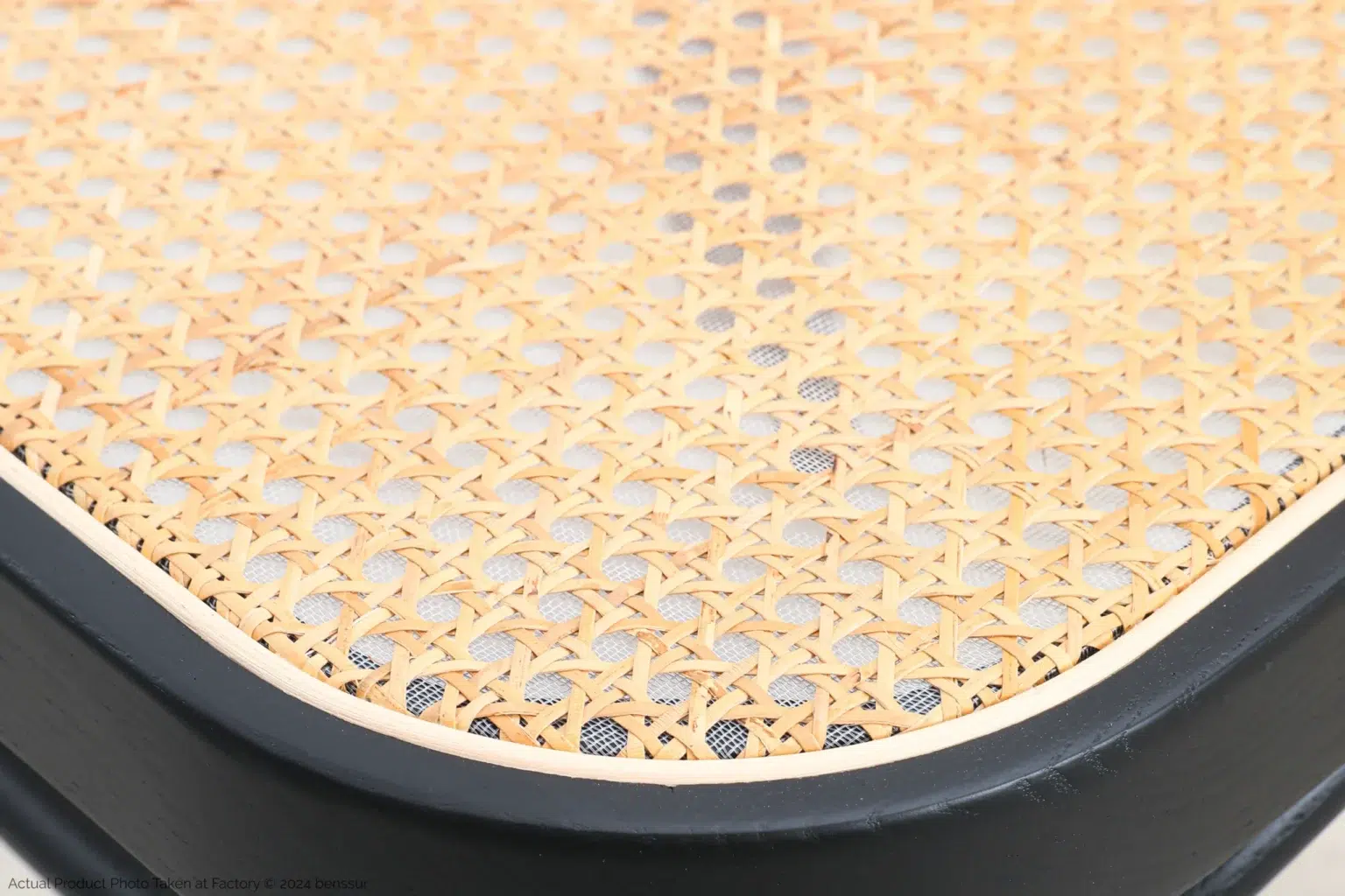 Josef Hoffmann_No811 Chair_Replica_Woven Caning_Black_Ash_Detail_5 Close-up of a woven cane or rattan seat with a light natural finish and black wooden frame, showing the detailed criss-cross pattern of the weaving.