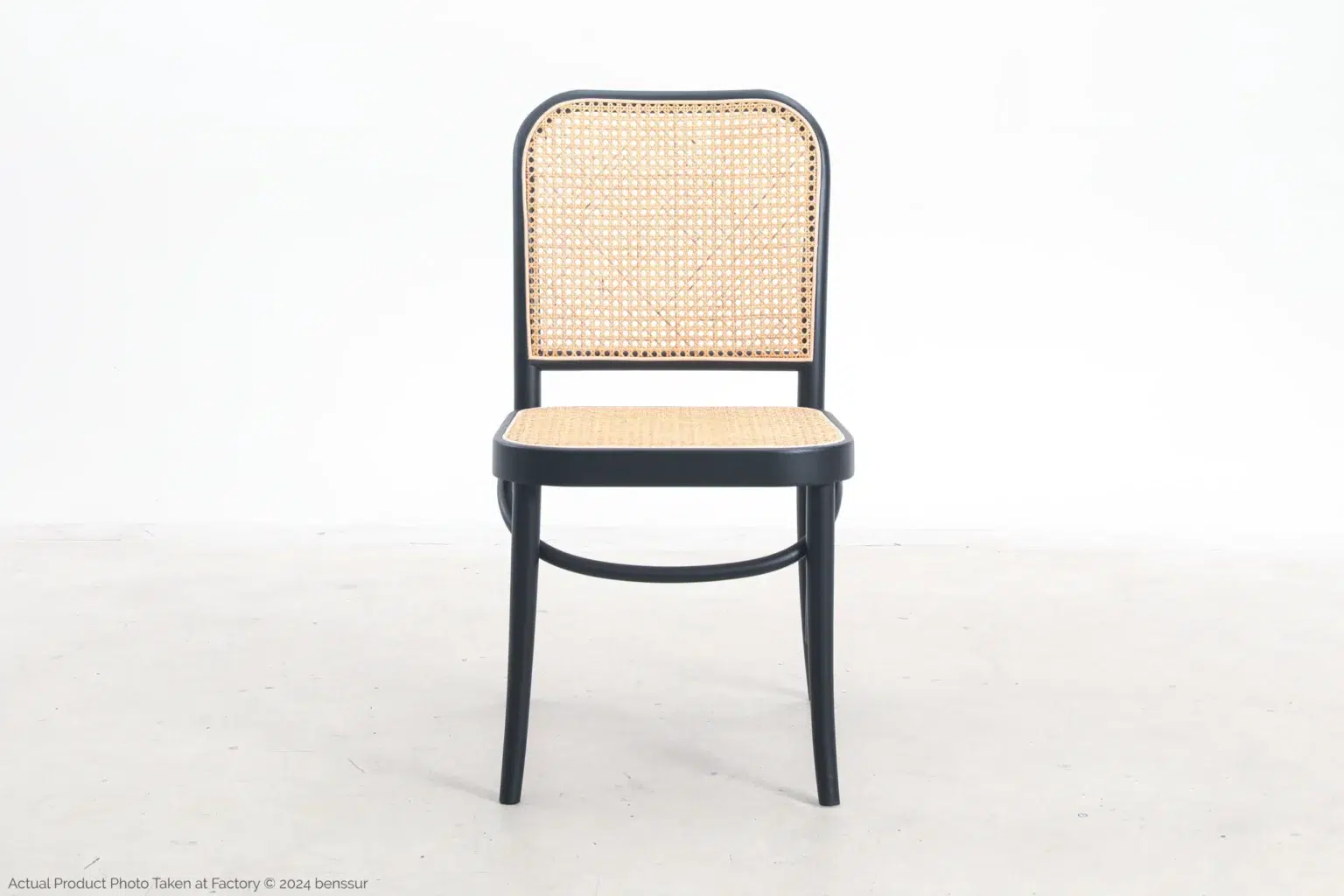 Josef Hoffmann_No811 Chair_Replica_Woven Caning_Black_Ash_Front A black wooden chair with a woven cane seat and backrest, positioned on a light-coloured floor against a plain white background.