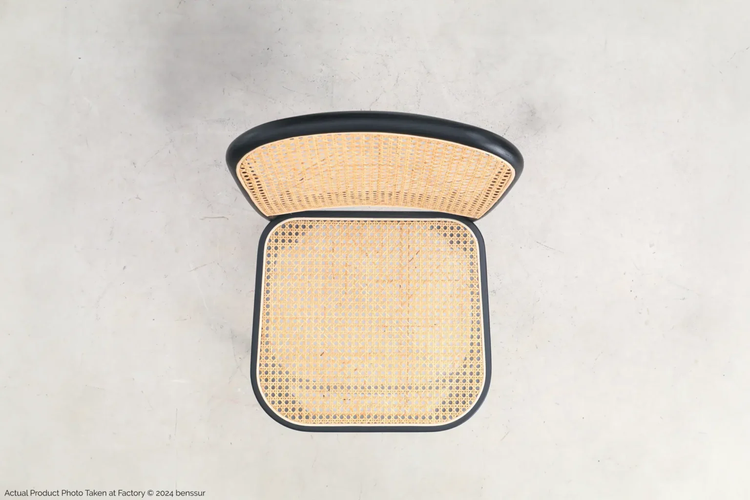 Josef Hoffmann_No811 Chair_Replica_Woven Caning_Black_Ash_Top Top-down view of a chair with a woven cane seat and backrest, featuring a black frame, placed on a light, smooth surface.