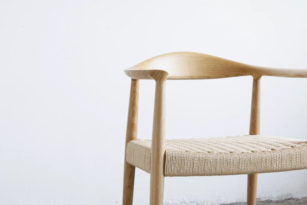 Detail of the backrest on Hans Wegner's Round Chair, highlighting the elegant European ash grain and smooth craftsmanship.