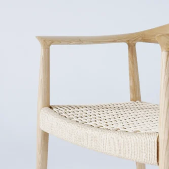 Photo of Hans Wegner's Round Chair with a paper rope seat, focusing on the intricate weave and craftsmanship of the seat, showcasing the natural texture and detailed workmanship in this classic design.