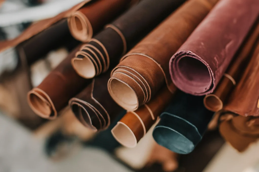 Various leather rolls in different colours, neatly stacked together.