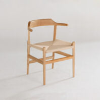A wooden chair with a curved backrest and woven seat, featuring simple, minimalist design on a plain white background.