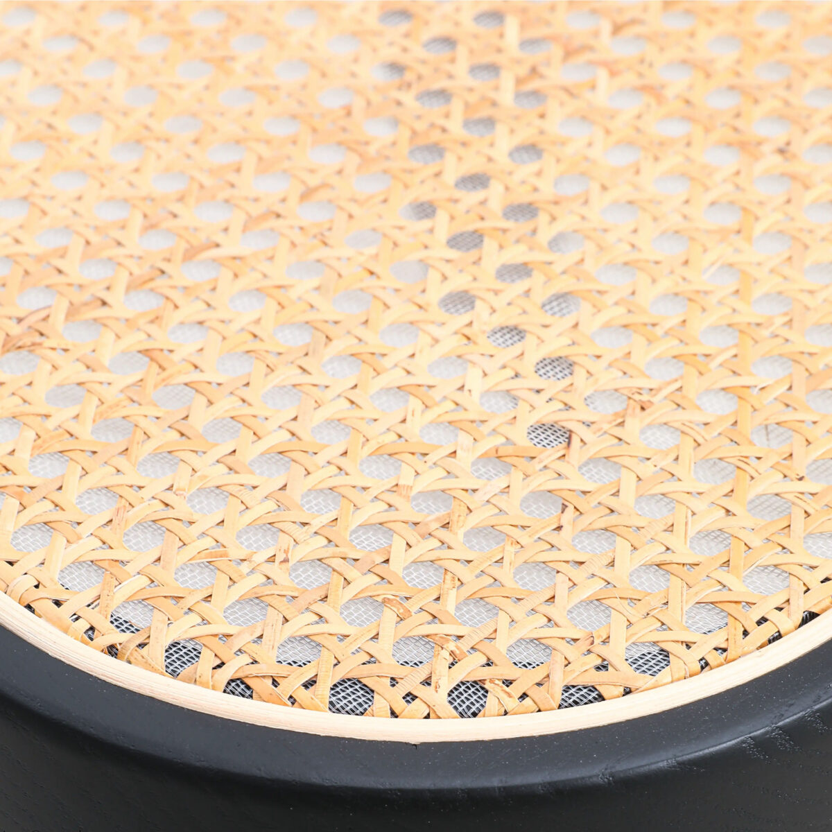 Rattan_B7 Close-up of a woven rattan cane seat with a black wooden frame, showing the intricate natural lattice pattern and texture.