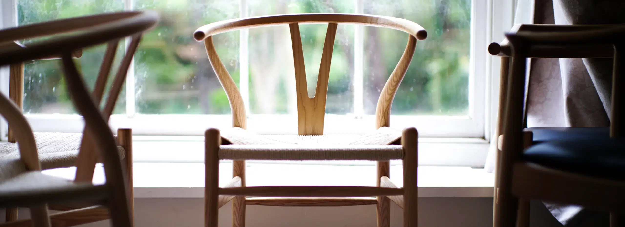 A group of beautiful dining chairs with a wishbone chair in the middle showing excellent natural grain.