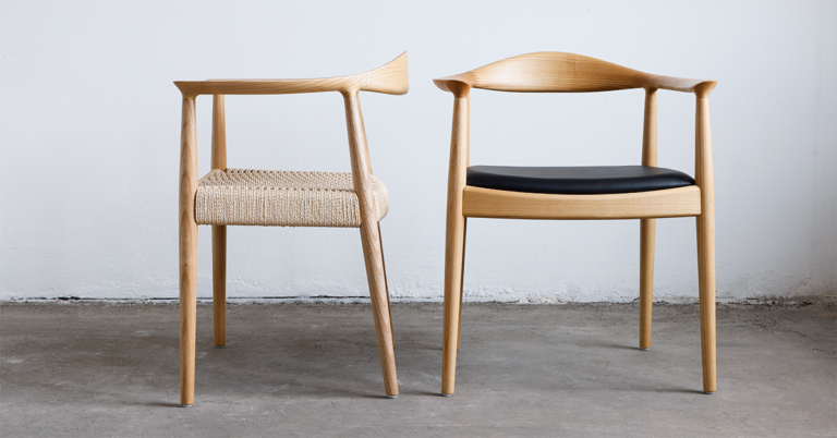 two round chair, one with black leather seat one with paper rope seat, each features natural color timber with rich grain and smooth edge.