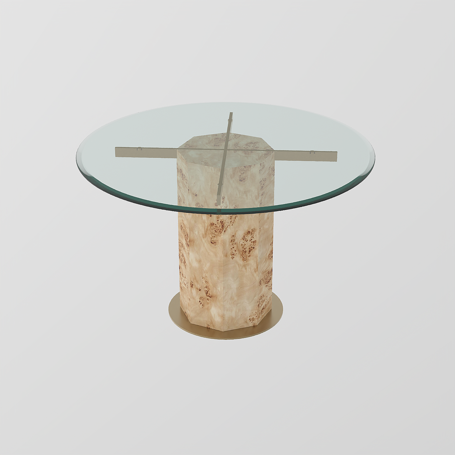 A modern round table with a clear glass top, metal cross supports, and a cylindrical base made of light-coloured, textured material, set against a plain white background.