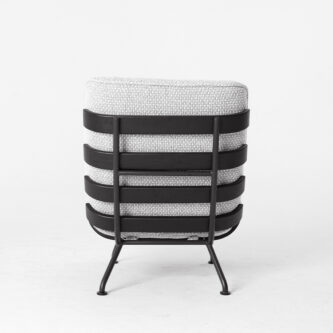 Back view of a modern lounge chair with light grey textured upholstery and a black metal frame featuring horizontal slat-style supports, photographed against a plain white background.