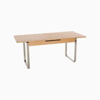 A rectangular wooden table with a light finish, featuring sleek metal sled legs and a minimalist design, set against a plain white background.