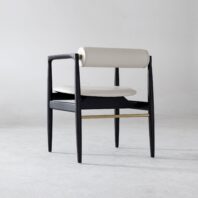 A modern chair with a black wooden frame, a rounded white-cushioned backrest, and a matching white seat, set against a plain light grey background.