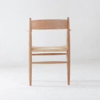 A wooden chair with a woven seat is shown from the back against a plain, light background. The chair has a minimalist design with clean lines and natural wood grain visible.