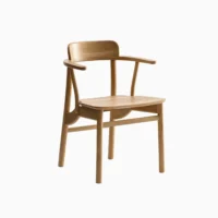 A modern wooden armchair with a curved backrest, angled armrests, and a smooth seat, set against a plain white background.