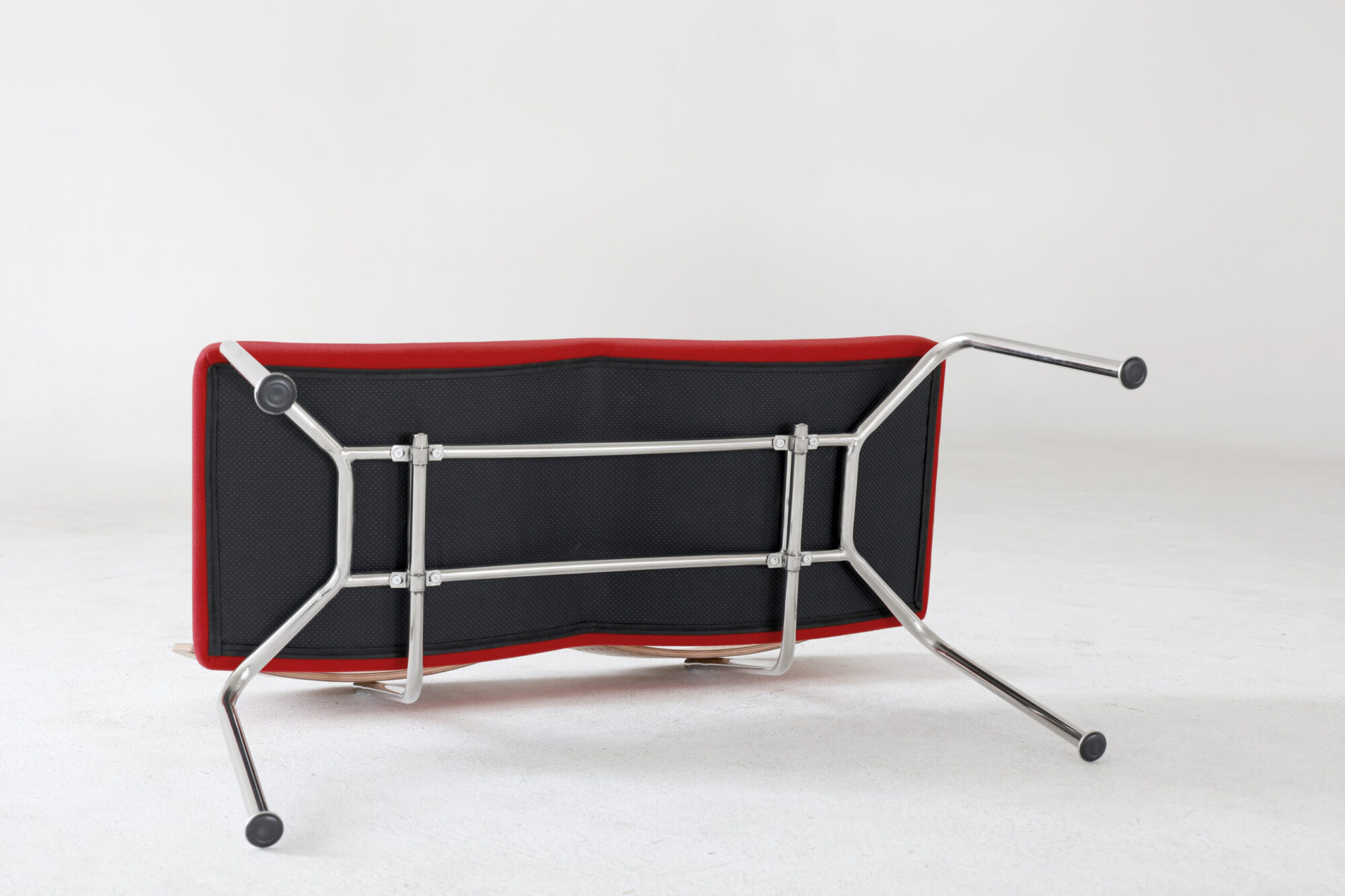 Flying Bench Red Seat Underside view of a red modern bench seat showing metal frame and support structure, shown on a plain white background.