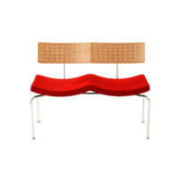 A modern bench with a perforated light wood backrest, a red wavy cushioned seat, and metal legs, set against a white background.