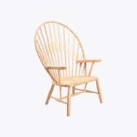 A wooden armchair with a high, rounded back made of vertical wooden spindles and a woven seat, set against a plain white background.