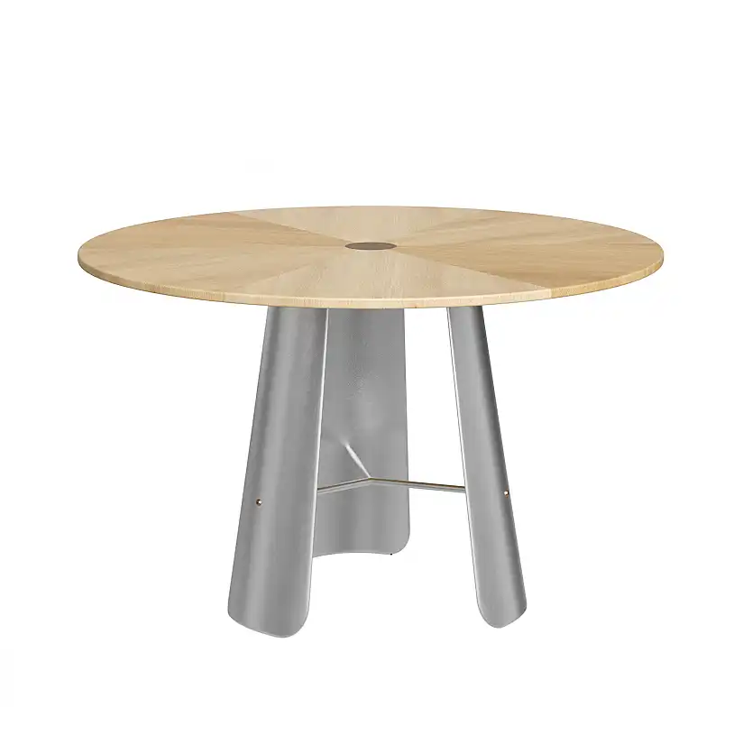 A round wooden table with a light wood top and three curved, silver metal legs connected by a horizontal metal bar at the base.