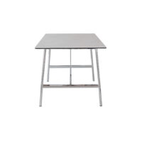 Rectangular table with a flat, dark-coloured top and four shiny, silver metal legs, viewed from the short end against a white background.