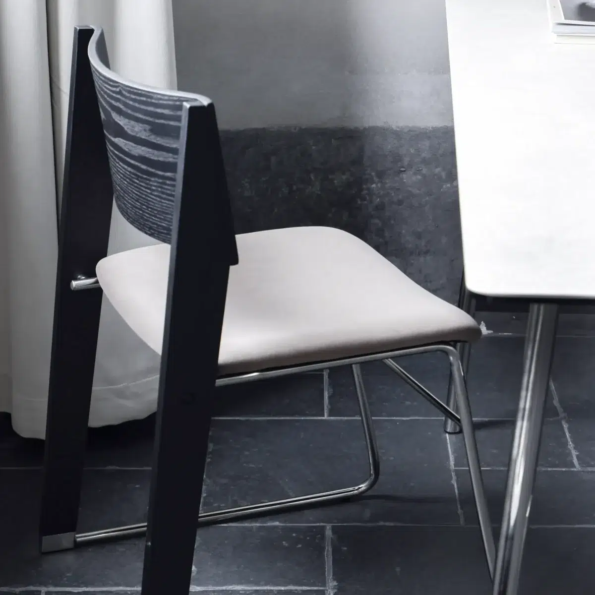 Walk Slowly Chair_Black_Back View(7) A chair next to a table.