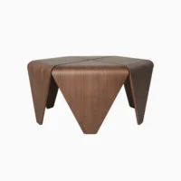 A modern, geometric coffee table with a smooth, rich wood finish and four triangular, downward-sloping legs, creating a sculptural and minimalist appearance on a white background.