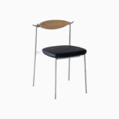 A modern chair with a minimalist design, featuring a black cushioned seat, slim metal legs, and a curved wooden backrest, set against a plain white background.
